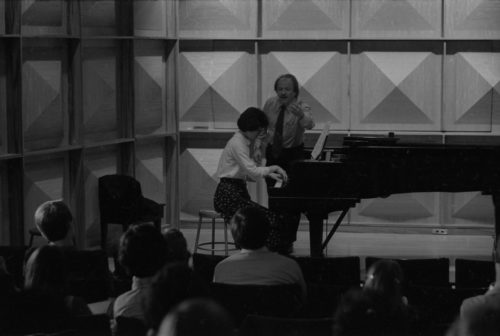 John Perry coaching an Eastman piano major on-stage in Howard Hanson Hall.