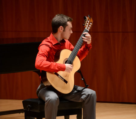 Riley Smith performs on guitar