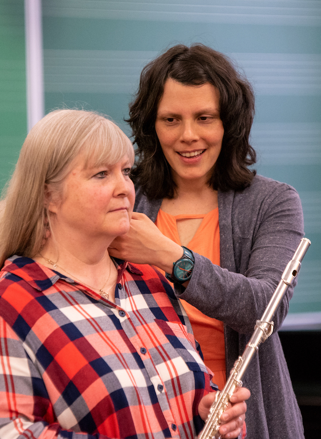 Katie Fittipaldi demonstrates the Alexander Technique on female student's neck