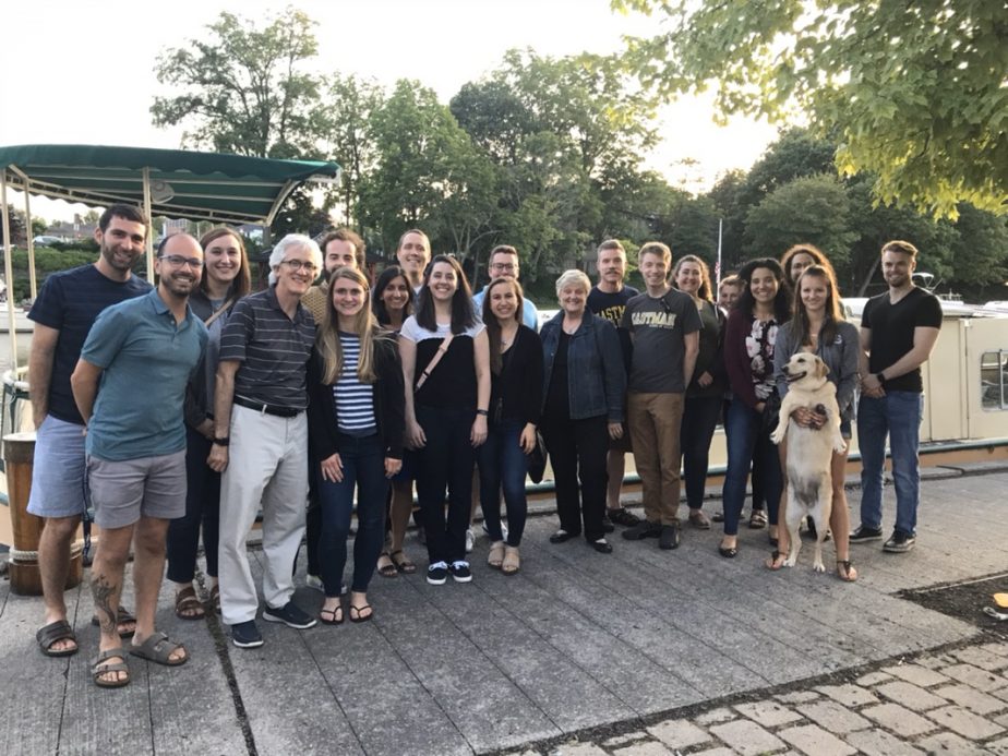 Instructors, students and a dog pose for a picture outside at Pittsford Dairy