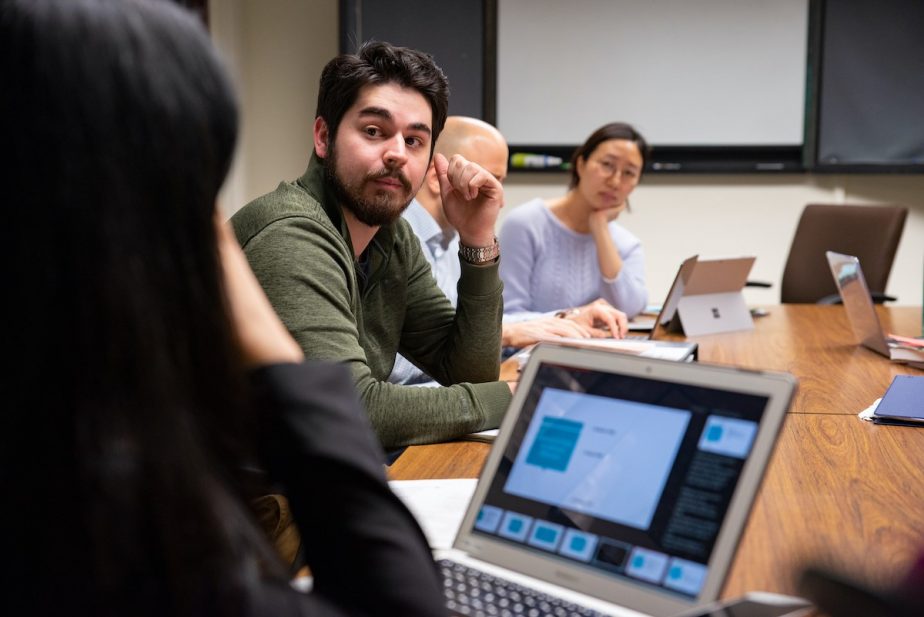 Teacher and students at table in small class