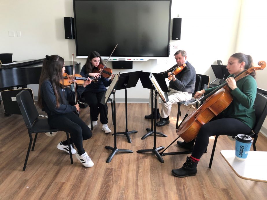 Chamber music group in practice room