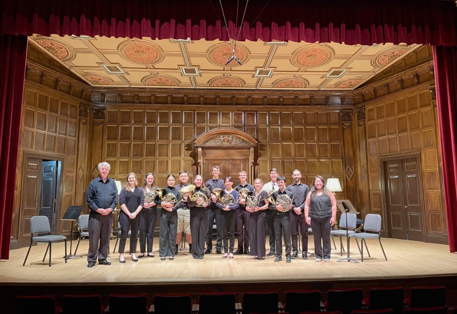 Horn Institute class group portrait on stage in Kilbourn Hall