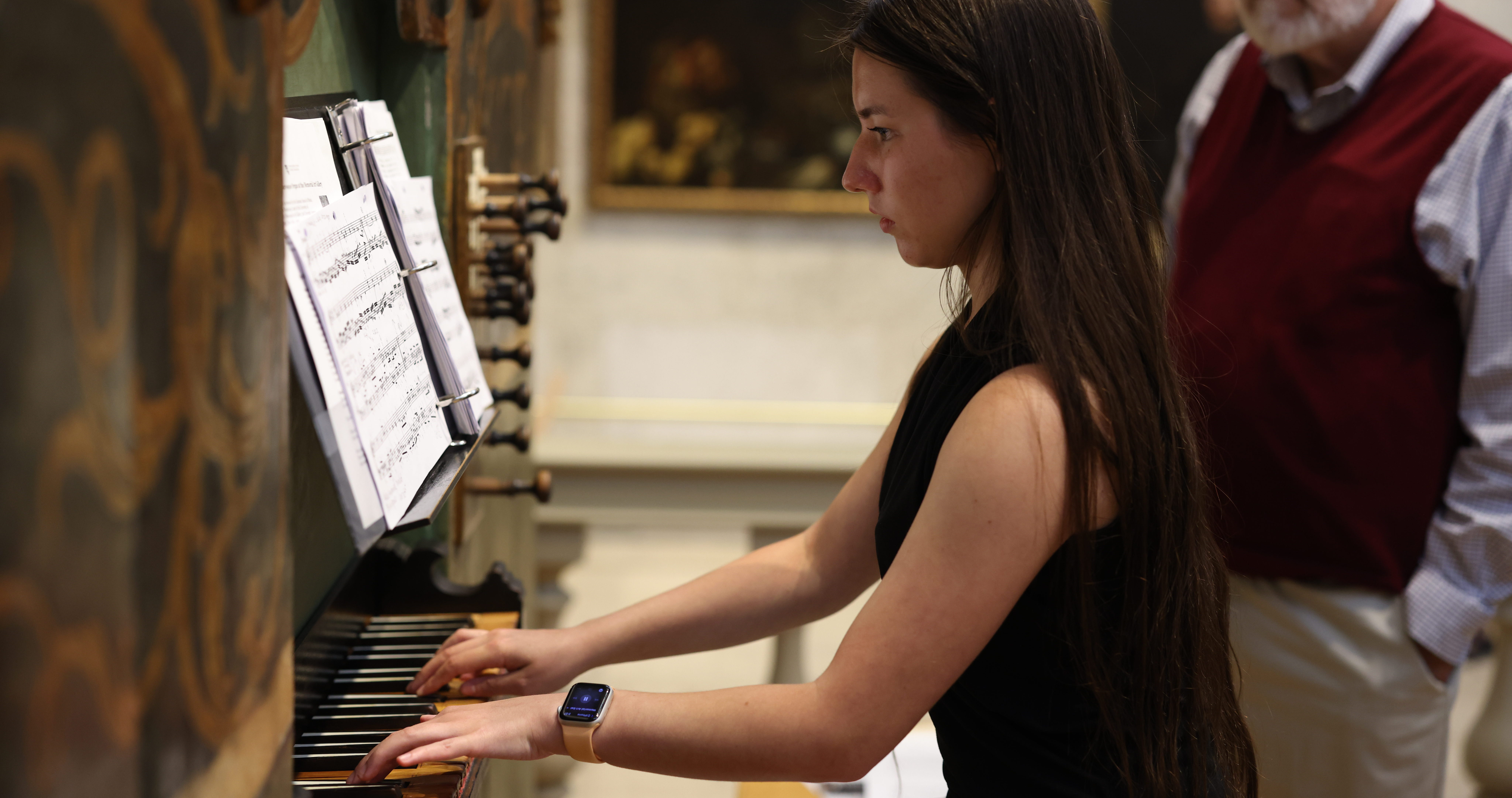 A woman performs on Baroque organ at the Memorial Art Gallery in Rochester, NY.